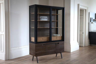 This is an example of a medium sized contemporary kitchen/dining room in London with white walls, light hardwood flooring, no fireplace and beige floors.