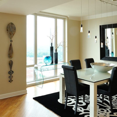 Example of a mid-sized trendy medium tone wood floor enclosed dining room design in Atlanta with beige walls