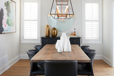 Enclosed dining room - transitional light wood floor enclosed dining room idea in Toronto with beige walls