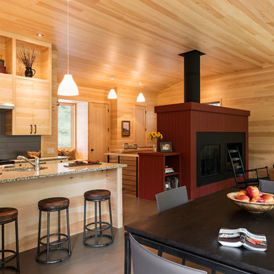 Great room - small rustic medium tone wood floor and brown floor great room idea in Other with a standard fireplace, a wood fireplace surround and beige walls