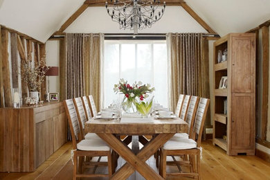 Photo of a large country dining room in Hertfordshire with white walls and medium hardwood flooring.