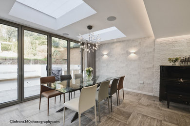 Inspiration for a modern open plan dining room in Hertfordshire with grey walls, porcelain flooring and grey floors.