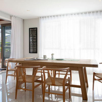 Inspiration for a contemporary dining room remodel in Melbourne with white walls