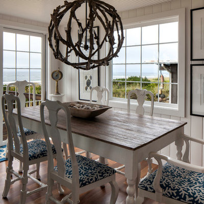 Inspiration for a coastal medium tone wood floor dining room remodel in Seattle with white walls