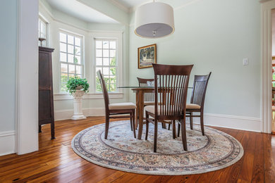 Example of an arts and crafts medium tone wood floor dining room design in Tampa