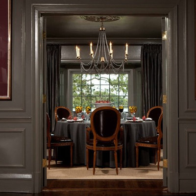 Large elegant dark wood floor enclosed dining room photo in Orlando with gray walls