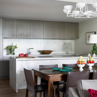 This is an example of a mid-sized contemporary open plan dining in Melbourne with white walls, medium hardwood floors and brown floor.