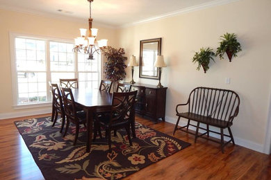 Example of a medium tone wood floor dining room design in Atlanta with beige walls