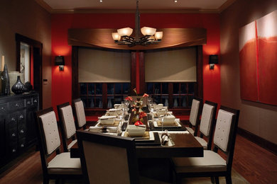 Example of a mid-sized minimalist medium tone wood floor enclosed dining room design in Other with multicolored walls and no fireplace