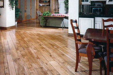 Inspiration for a large timeless medium tone wood floor great room remodel in Other with white walls and no fireplace