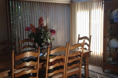 Example of a mid-sized transitional enclosed dining room design in Other with white walls