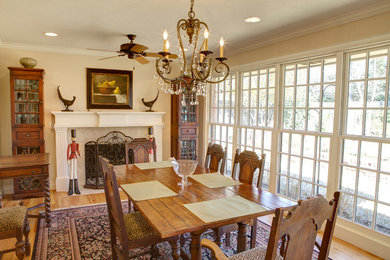 Inspiration for a mid-sized timeless light wood floor and beige floor enclosed dining room remodel in Oklahoma City with beige walls, a standard fireplace and a tile fireplace