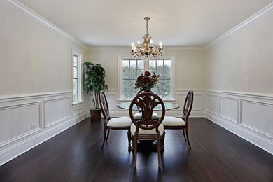 Example of a mid-sized classic dark wood floor and brown floor enclosed dining room design in Orlando with beige walls and no fireplace