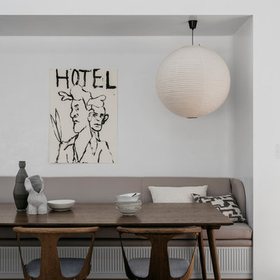 Example of a mid-sized trendy light wood floor and brown floor kitchen/dining room combo design in Sydney with white walls