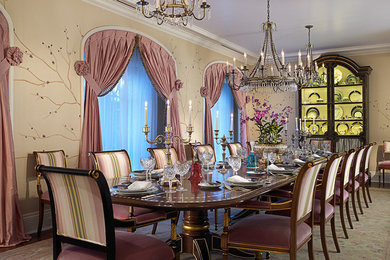 Large elegant medium tone wood floor enclosed dining room photo in Miami with beige walls and no fireplace
