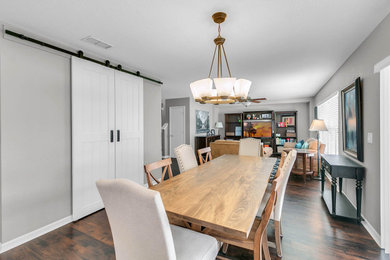 Example of a mid-sized transitional laminate floor and brown floor kitchen/dining room combo design in Orlando with gray walls