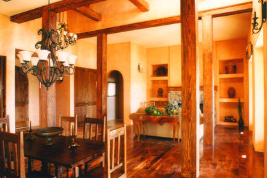 Example of a large mountain style carpeted and brown floor enclosed dining room design in Boise with beige walls, a standard fireplace and a stone fireplace