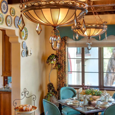Example of a tuscan dark wood floor dining room design in Los Angeles with beige walls