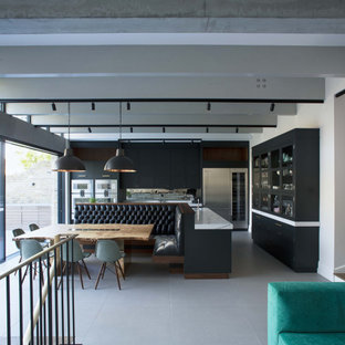 Design ideas for a contemporary open plan dining room in London with white walls, grey floors and exposed beams.