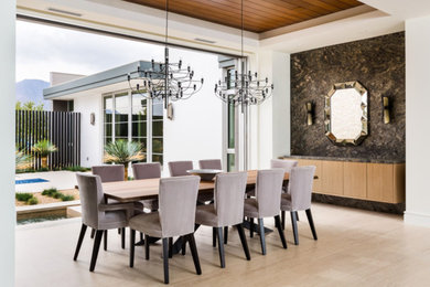 Dining room - large modern light wood floor dining room idea in Los Angeles with white walls