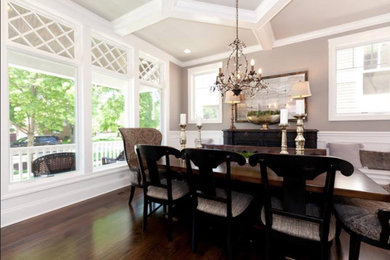 Example of a mid-sized classic dark wood floor and brown floor dining room design in Miami with beige walls