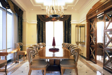 Dining room - transitional marble floor dining room idea in New York with yellow walls