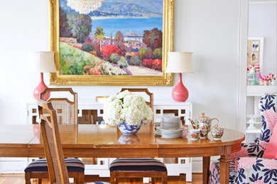 Example of an eclectic medium tone wood floor dining room design in Philadelphia with white walls