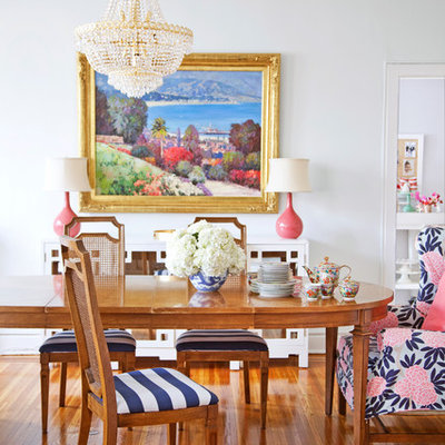 Example of an eclectic medium tone wood floor dining room design in Philadelphia with white walls