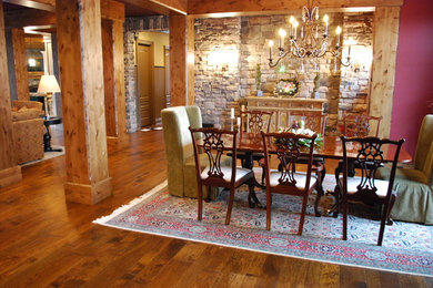 Mid-sized mountain style medium tone wood floor and brown floor dining room photo in Cleveland with red walls and no fireplace