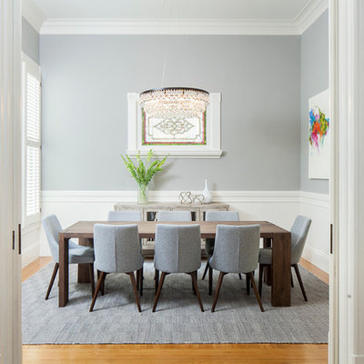 Inspiration for a transitional medium tone wood floor enclosed dining room remodel in San Francisco with gray walls