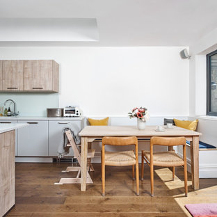 Photo of a medium sized contemporary kitchen/dining room in Other with white walls, medium hardwood flooring and brown floors.
