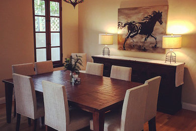 Mid-sized tuscan light wood floor dining room photo in Los Angeles with beige walls