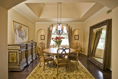 Inspiration for a large mediterranean enclosed dining room in Phoenix with beige walls and dark hardwood flooring.