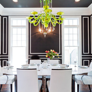 Example of a trendy dark wood floor enclosed dining room design in Houston with black walls