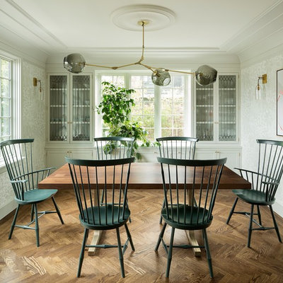 Enclosed dining room - mid-sized transitional dark wood floor and brown floor enclosed dining room idea in Portland with white walls