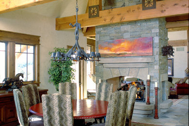 Inspiration for a large rustic multicolored floor enclosed dining room remodel in Denver with beige walls, a two-sided fireplace and a stone fireplace