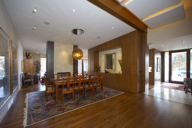 Great room - traditional dark wood floor and brown floor great room idea in Calgary with a two-sided fireplace