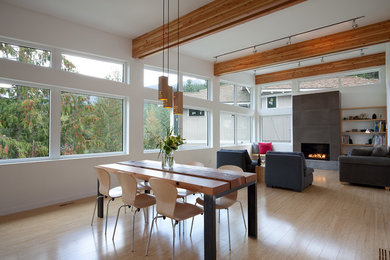 Example of a mid-sized trendy bamboo floor dining room design in Vancouver with white walls