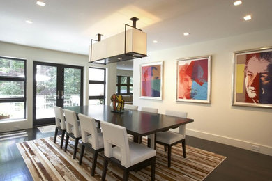 Example of a light wood floor dining room design in New York with white walls