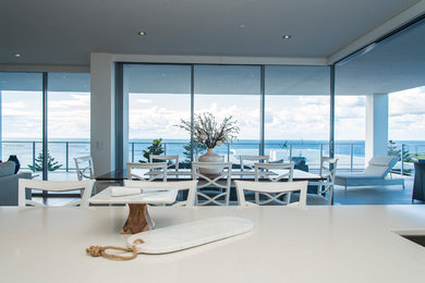 This is an example of a coastal dining room in Other.