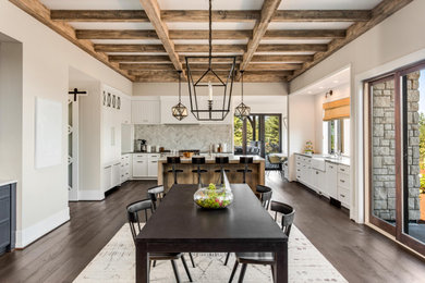 Inspiration for a farmhouse dark wood floor, brown floor and exposed beam great room remodel in New York with beige walls