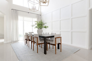 Example of a trendy gray floor dining room design in Miami with white walls