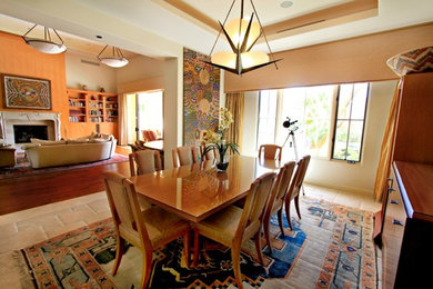 Example of a mid-sized tuscan travertine floor enclosed dining room design in Los Angeles with beige walls and no fireplace