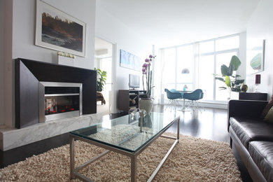 Example of a mid-sized trendy dark wood floor dining room design in Toronto with white walls and a wood fireplace surround