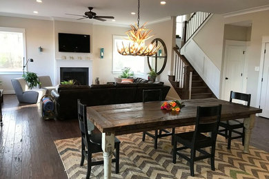 Example of a mid-sized mountain style dark wood floor and brown floor great room design in Philadelphia with beige walls and no fireplace