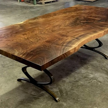 Raw edge claro walnut dining table with steel infinty leg