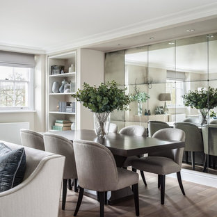 Medium sized classic dining room in London with beige walls, light hardwood flooring and beige floors.