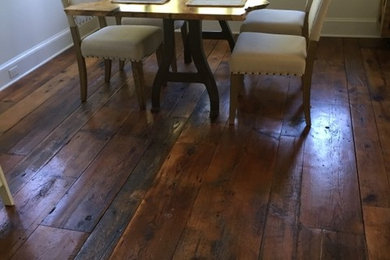 Example of a small classic dark wood floor and brown floor enclosed dining room design in New York with beige walls and no fireplace