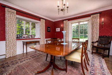 Large classic enclosed dining room in West Midlands with red walls and dark hardwood flooring.