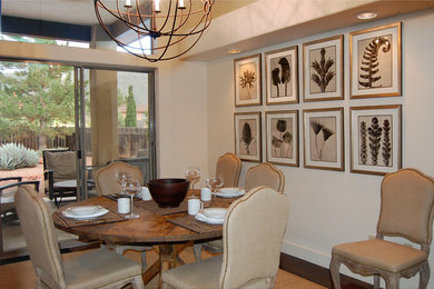 Example of a mid-sized transitional medium tone wood floor and brown floor enclosed dining room design in Phoenix with beige walls and no fireplace